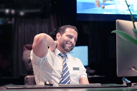 Hotel manager male reception Suffering From Neck Pain. Bearded man. Male Feeling Tired, Exhausted, Stressed. Men Massaging Painful Neck With Hands. Body And Health Care Concept.の写真素材