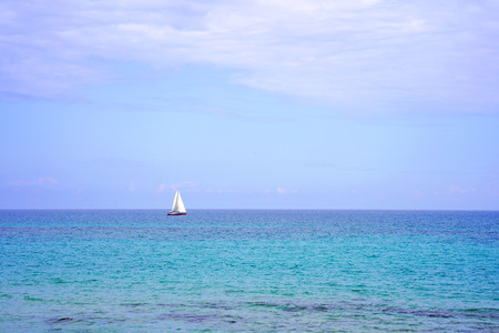 Yacht on the sea horizon on a summer day