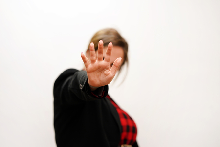 Woman hide her face at hand isolated on white background. Woman holding her hand stretched out...
