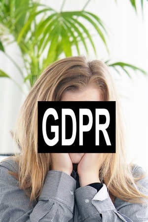 GDPR - young woman face is hidden behind the inscription General Data Protection Regulation. Cyber security and privacy.の写真素材
