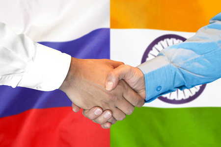 Business handshake on the background of two flags. Men handshake on the background of the India and Russia flag. Support conceptの写真素材