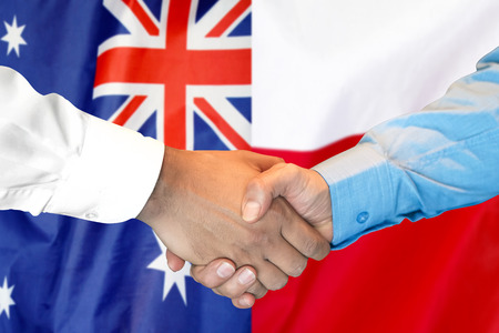 Business handshake on the background of two flags. Men handshake on the background of the Australia and Poland flag. Support conceptの写真素材