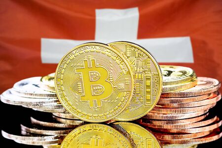 Concept for investors in cryptocurrency and Blockchain technology in the Switzerland. Bitcoins on the background of the flag Switzerland.の写真素材