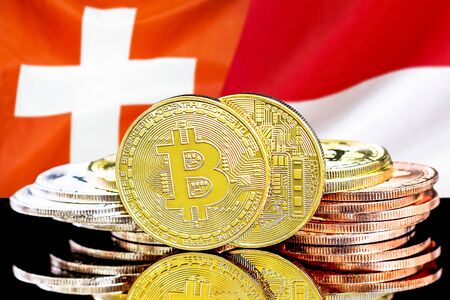Concept for investors in cryptocurrency and Blockchain technology in the Switzerland and Monaco. Bitcoins on the background of the flag Switzerland and Monaco.の写真素材