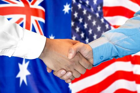 Business handshake on the background of two flags. Men handshake on the background of the Australia and United States of America flag. Support conceptの写真素材