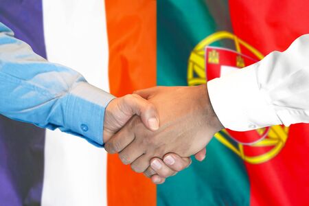 Business handshake on the background of two flags. Men handshake on the background of the France and Portugal flag. Support conceptの写真素材