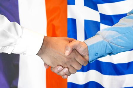 Business handshake on the background of two flags. Men handshake on the background of the France and Greece flag. Support conceptの写真素材