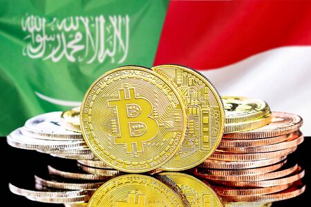 Concept for investors in cryptocurrency and Blockchain technology in the Saudi Arabia and Monaco. Bitcoins on the background of the flag Saudi Arabia and Monaco.の写真素材