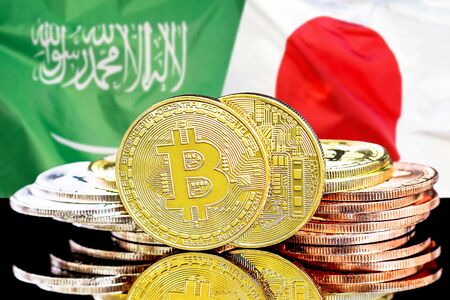 Concept for investors in cryptocurrency and Blockchain technology in the Saudi Arabia and Japan. Bitcoins on the background of the flag Saudi Arabia and Japan.の写真素材
