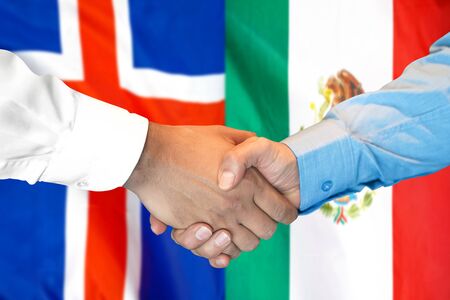 Business handshake on the background of two flags. Men handshake on the background of the Iceland and Mexico flag. Support conceptの写真素材