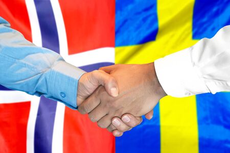 Business handshake on the background of two flags. Men handshake on the background of the Norway and Sweden flag. Support conceptの写真素材