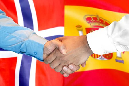 Business handshake on the background of two flags. Men handshake on the background of the Norway and Spain flag. Support conceptの写真素材