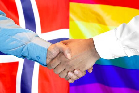 Business handshake on the background of two flags. Men handshake on the background of the Norway and LGBT gay flag. Support conceptの写真素材