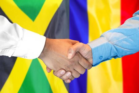 Business handshake on the background of two flags. Men handshake on the background of the Jamaica and Moldova flag. Support conceptの写真素材