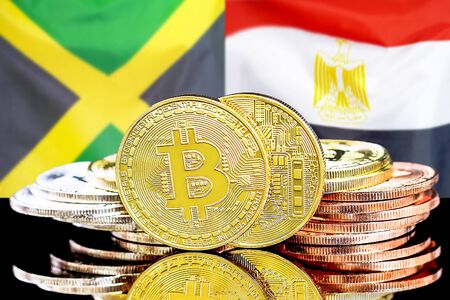 Concept for investors in cryptocurrency and Blockchain technology in the Jamaica and Egypt. Bitcoins on the background of the flag Jamaica and Egypt.の写真素材