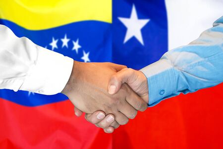 Business handshake on the background of two flags. Men handshake on the background of the Venezuela and Chile flag. Support conceptの写真素材