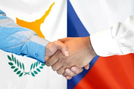 Business handshake on the background of two flags. Men handshake on the background of the Cyprus and Czech Republic flag. Support conceptの写真素材