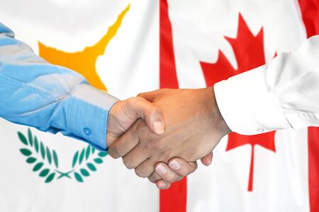 Business handshake on the background of two flags. Men handshake on the background of the Cyprus and Canada flag. Support conceptの写真素材