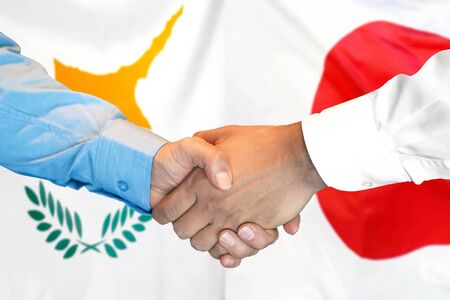 Business handshake on the background of two flags. Men handshake on the background of the Cyprus and Japan flag. Support conceptの写真素材