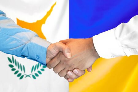 Business handshake on the background of two flags. Men handshake on the background of the Cyprus and Ukraine flag. Support conceptの写真素材