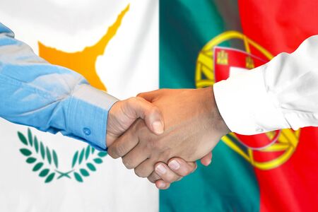 Business handshake on the background of two flags. Men handshake on the background of the Cyprus and Portugal flag. Support conceptの写真素材