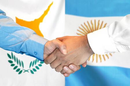Business handshake on the background of two flags. Men handshake on the background of the Cyprus and Argentina flag. Support conceptの写真素材