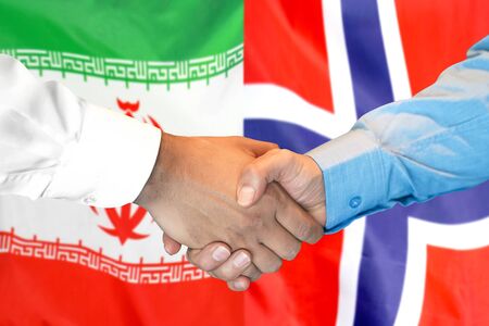 Business handshake on the background of two flags. Men handshake on the background of the Iran and Norway flag. Support conceptの写真素材