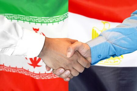Business handshake on the background of two flags. Men handshake on the background of the Iran and Egypt flag. Support conceptの写真素材
