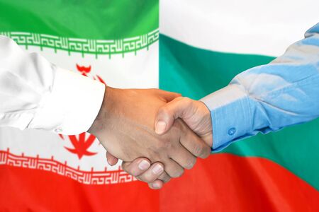 Business handshake on the background of two flags. Men handshake on the background of the Iran and Bulgaria flag. Support conceptの写真素材