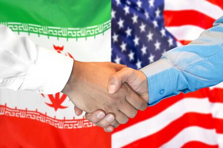 Business handshake on the background of two flags. Men handshake on the background of the Iran and United States of America flag. Support conceptの写真素材
