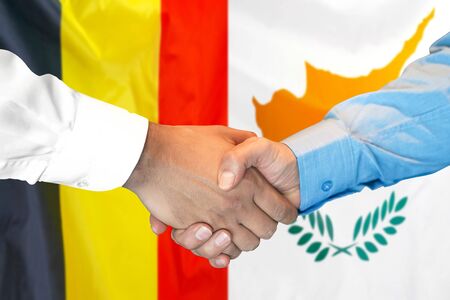 Business handshake on the background of two flags. Men handshake on the background of the Belgium and Cyprus flag. Support conceptの写真素材