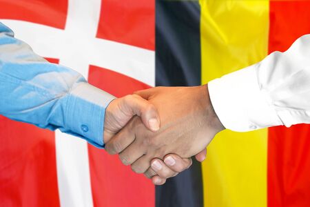 Business handshake on the background of two flags. Men handshake on the background of the Belgium and Denmark flag. Support conceptの写真素材