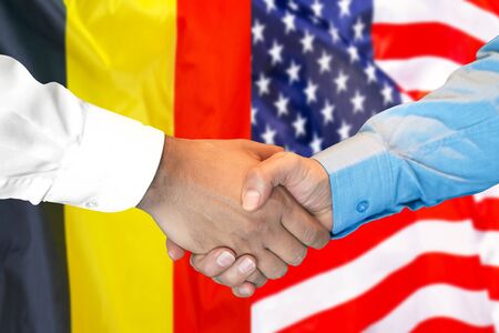 Business handshake on the background of two flags. Men handshake on the background of the Belgium and United States of America flag. Support conceptの写真素材