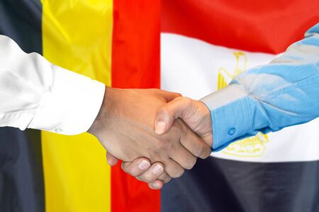 Business handshake on the background of two flags. Men handshake on the background of the Belgium and Egypt flag. Support conceptの写真素材