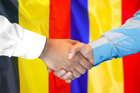 Business handshake on the background of two flags. Men handshake on the background of the Belgium and Moldova flag. Support conceptの写真素材