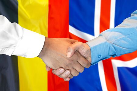 Business handshake on the background of two flags. Men handshake on the background of the Belgium and Iceland flag. Support conceptの写真素材