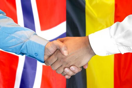 Business handshake on the background of two flags. Men handshake on the background of the Belgium and Norway flag. Support conceptの写真素材