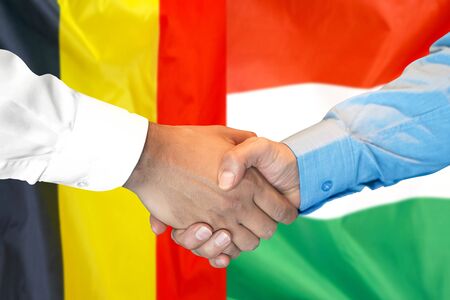 Business handshake on the background of two flags. Men handshake on the background of the Belgium and Hungary flag. Support conceptの写真素材