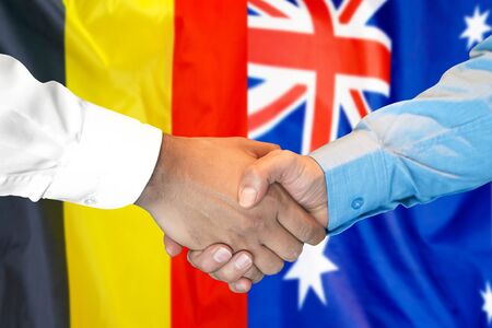 Business handshake on the background of two flags. Men handshake on the background of the Belgium and Australia flag. Support conceptの写真素材