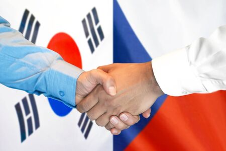Business handshake on the background of two flags. Men handshake on the background of the South Korea and Czech Republic flag. Support conceptの写真素材