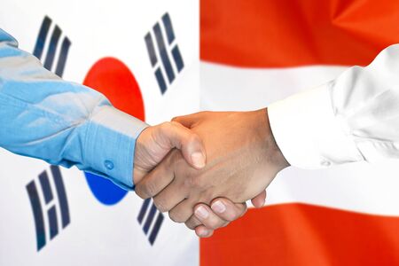 Business handshake on the background of two flags. Men handshake on the background of the South Korea and Austria flag. Support conceptの写真素材