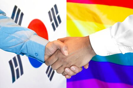 Business handshake on the background of two flags. Men handshake on the background of the South Korea and LGBT gay flag. Support conceptの写真素材