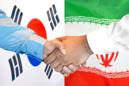 Business handshake on the background of two flags. Men handshake on the background of the South Korea and Iran flag. Support conceptの写真素材