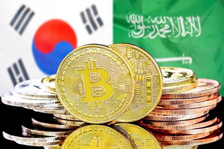 Concept for investors in cryptocurrency and Blockchain technology in the South Korea and Saudi Arabia. Bitcoins on the background of the flag South Korea and Saudi Arabia.の写真素材