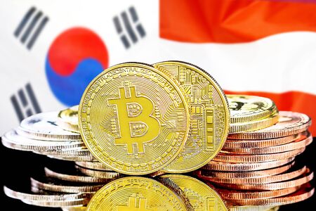 Concept for investors in cryptocurrency and Blockchain technology in the South Korea and Austria. Bitcoins on the background of the flag South Korea and Austria.の写真素材