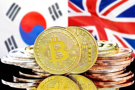 Concept for investors in cryptocurrency and Blockchain technology in the South Korea and United Kingdom. Bitcoins on the background of the flag South Korea and UK.の写真素材