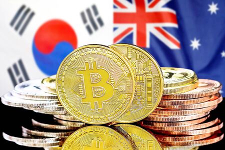 Concept for investors in cryptocurrency and Blockchain technology in the South Korea and Australia. Bitcoins on the background of the flag South Korea and Australia.の写真素材
