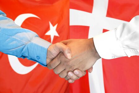 Business handshake on the background of two flags. Men handshake on the background of the Turkey and Denmark flag. Support conceptの写真素材