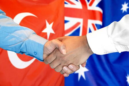 Business handshake on the background of two flags. Men handshake on the background of the Turkey and Australia flag. Support conceptの写真素材