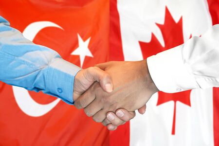 Business handshake on the background of two flags. Men handshake on the background of the Turkey and Canada flag. Support conceptの写真素材